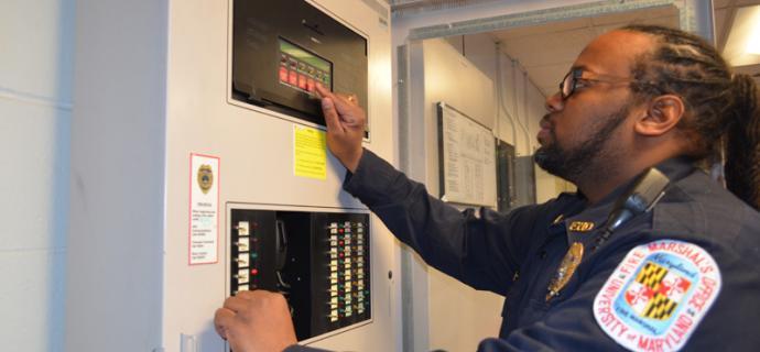 ESSR staff member looking at an open fuse box