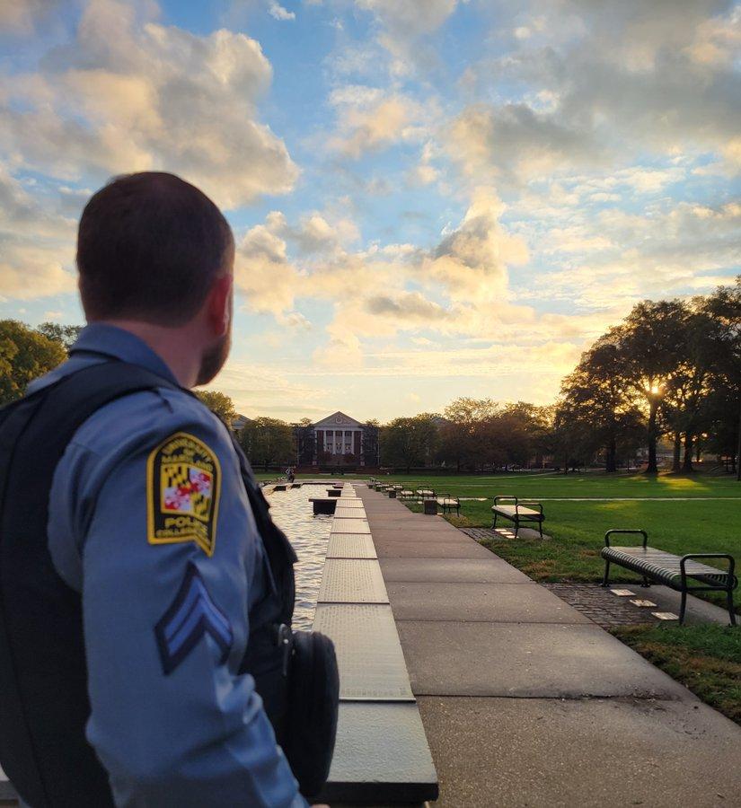 Male pubic safety officer looks down UMD mall at sunset